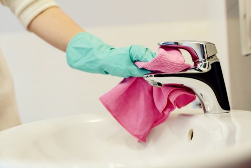 Team applying a health and safety policy during routine cleaning work