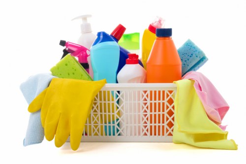 Domestic cleaner in Putney vacuuming a bright living room