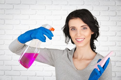 Worker using safe housekeeping practices during cleaning duties